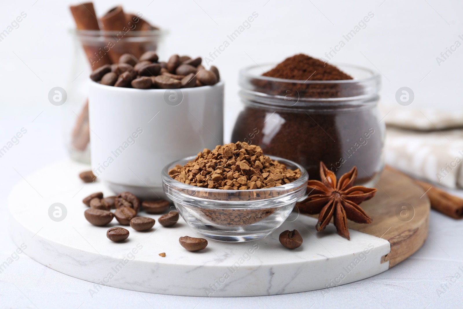 Different types of instant coffee, beans and spices on light table, closeup Photo of Different types of instant coffee, beans and spices on light table, closeup