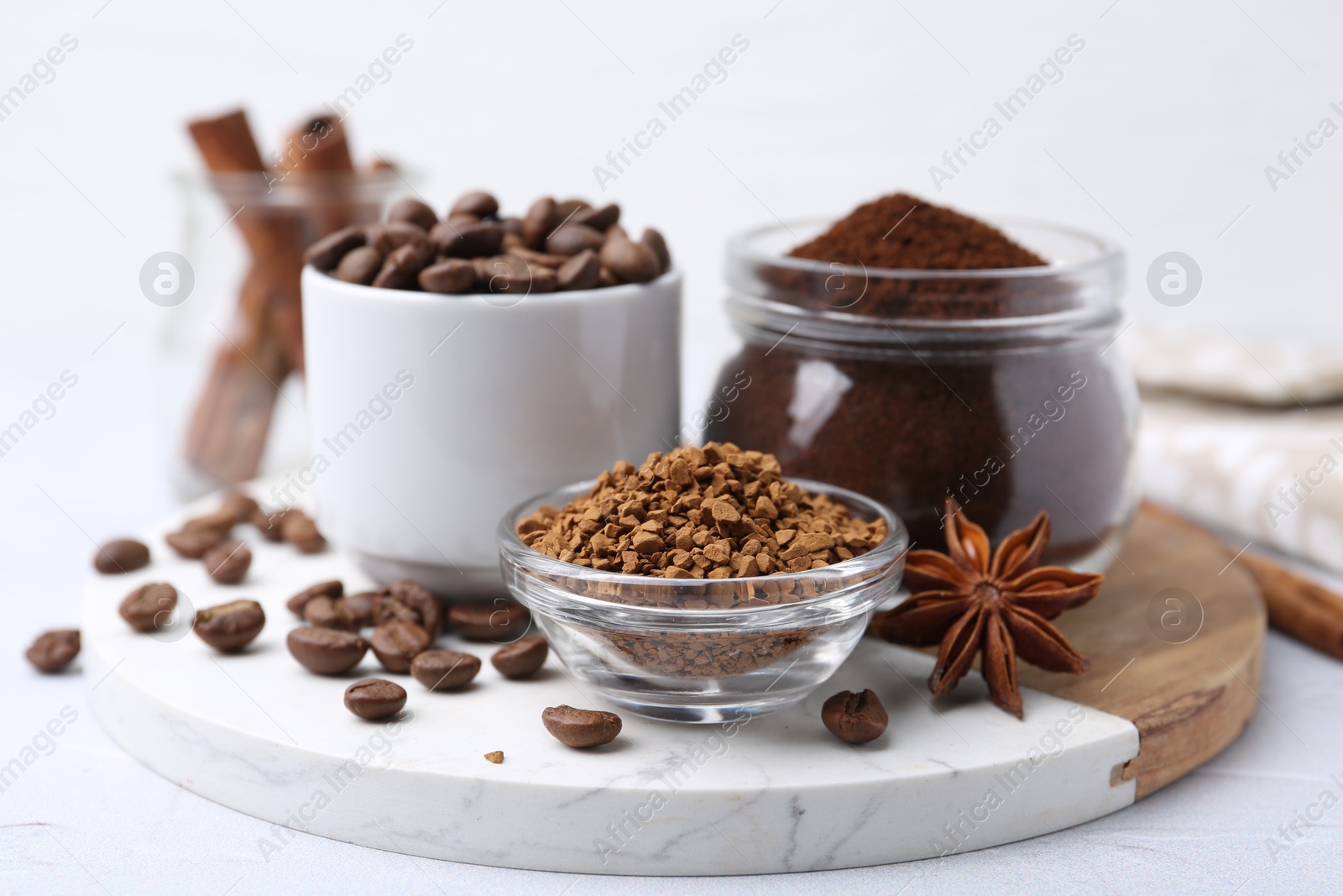 Different types of instant coffee, beans and spices on light table, closeup Photo of Different types of instant coffee, beans and spices on light table, closeup