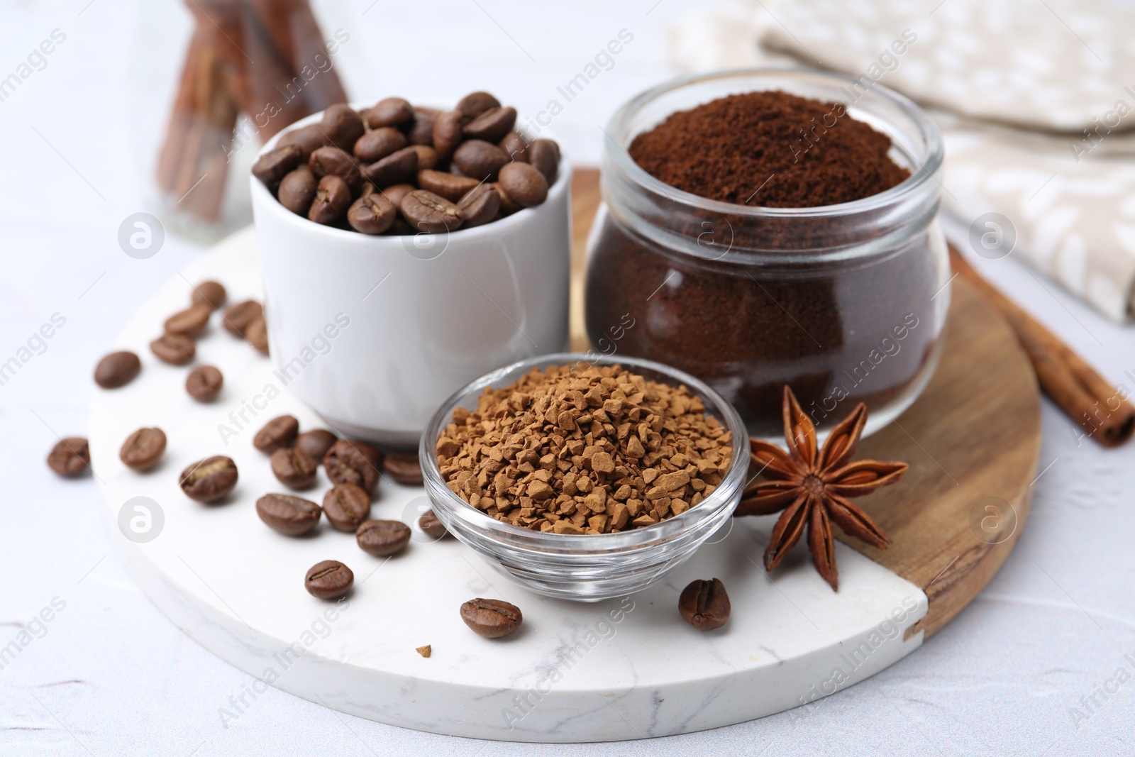 Different types of instant coffee, beans and spices on light textured table, closeup Photo of Different types of instant coffee, beans and spices on light textured table, closeup