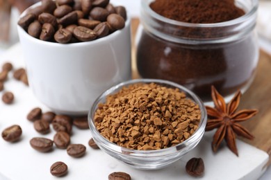 Photo of Different types of instant coffee, beans and spices on table, closeup