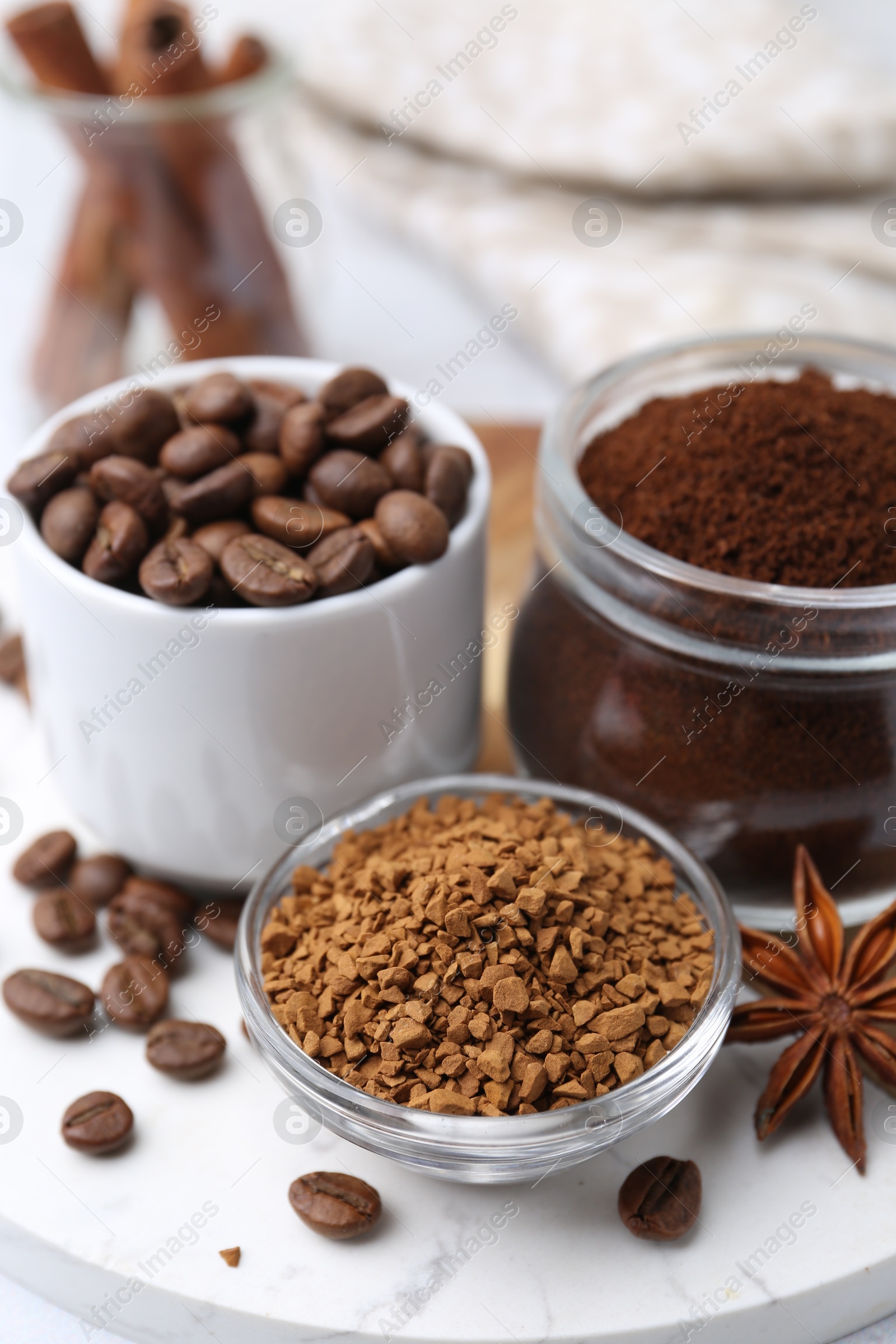 Different types of instant coffee, beans and spices on table, closeup Photo of Different types of instant coffee, beans and spices on table, closeup