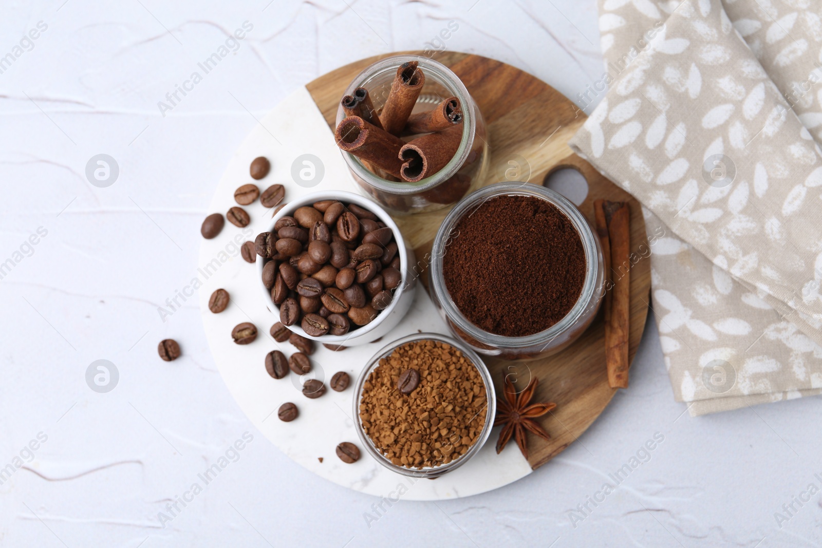 Different types of instant coffee, beans and spices on light textured table, top view Photo of Different types of instant coffee, beans and spices on light textured table, top view