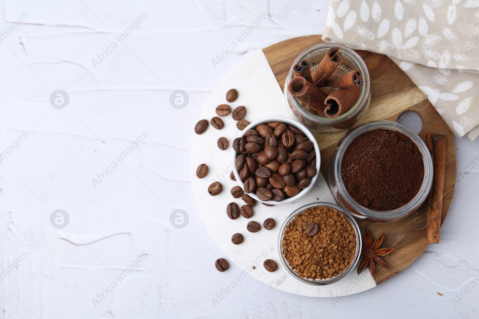Different types of instant coffee, beans and spices on light textured table, top view. Space for text Photo of Different types of instant coffee, beans and spices on light textured table, top view. Space for text