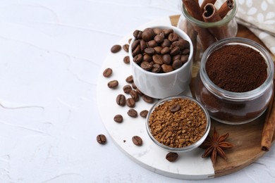 Photo of Different types of instant coffee, beans and spices on light textured table, closeup. Space for text