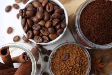 Photo of Different types of instant coffee, beans and spices on light table, flat lay