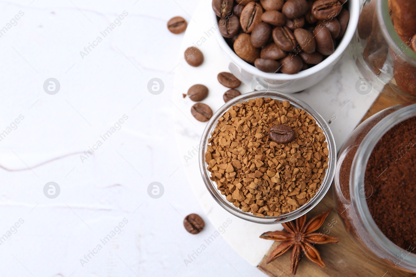 Different types of instant coffee, beans and spices on light textured table, top view. Space for text Photo of Different types of instant coffee, beans and spices on light textured table, top view. Space for text