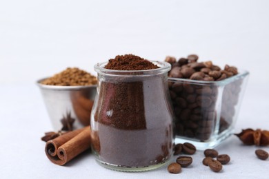 Photo of Different types of instant coffee, beans and spices on light table, closeup