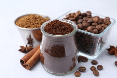 Photo of Different types of instant coffee, beans and spices on light table, closeup