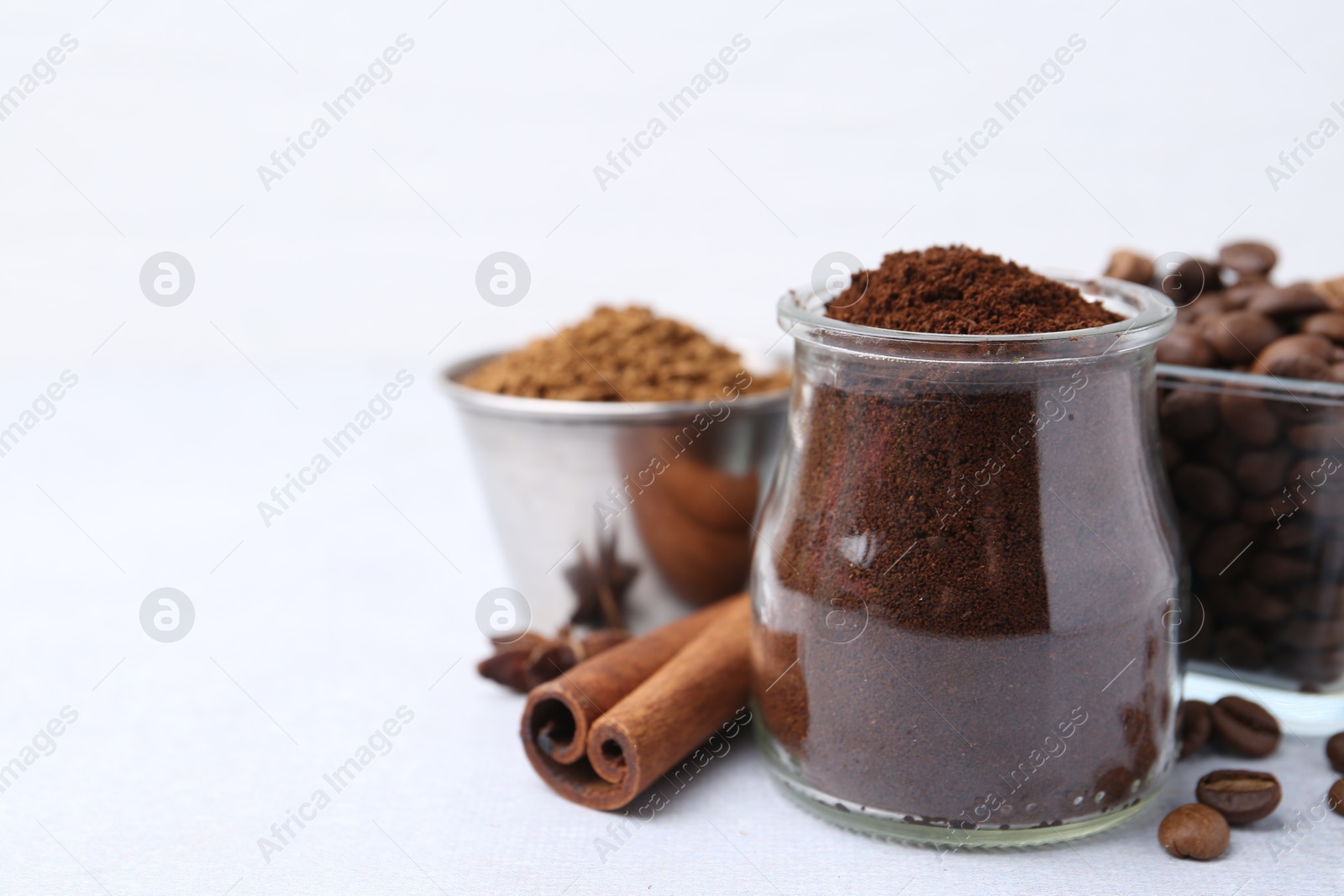 Different types of instant coffee, beans and spices on light table, closeup. Space for text Photo of Different types of instant coffee, beans and spices on light table, closeup. Space for text