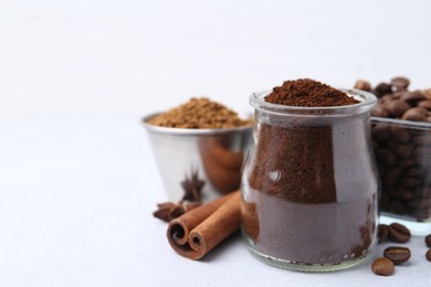 Photo of Different types of instant coffee, beans and spices on light table, closeup. Space for text