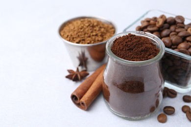 Photo of Different types of instant coffee, beans and spices on light table, closeup. Space for text