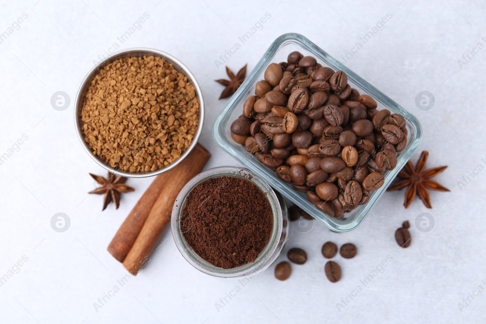 Different types of instant coffee, beans and spices on light table, flat lay Photo of Different types of instant coffee, beans and spices on light table, flat lay