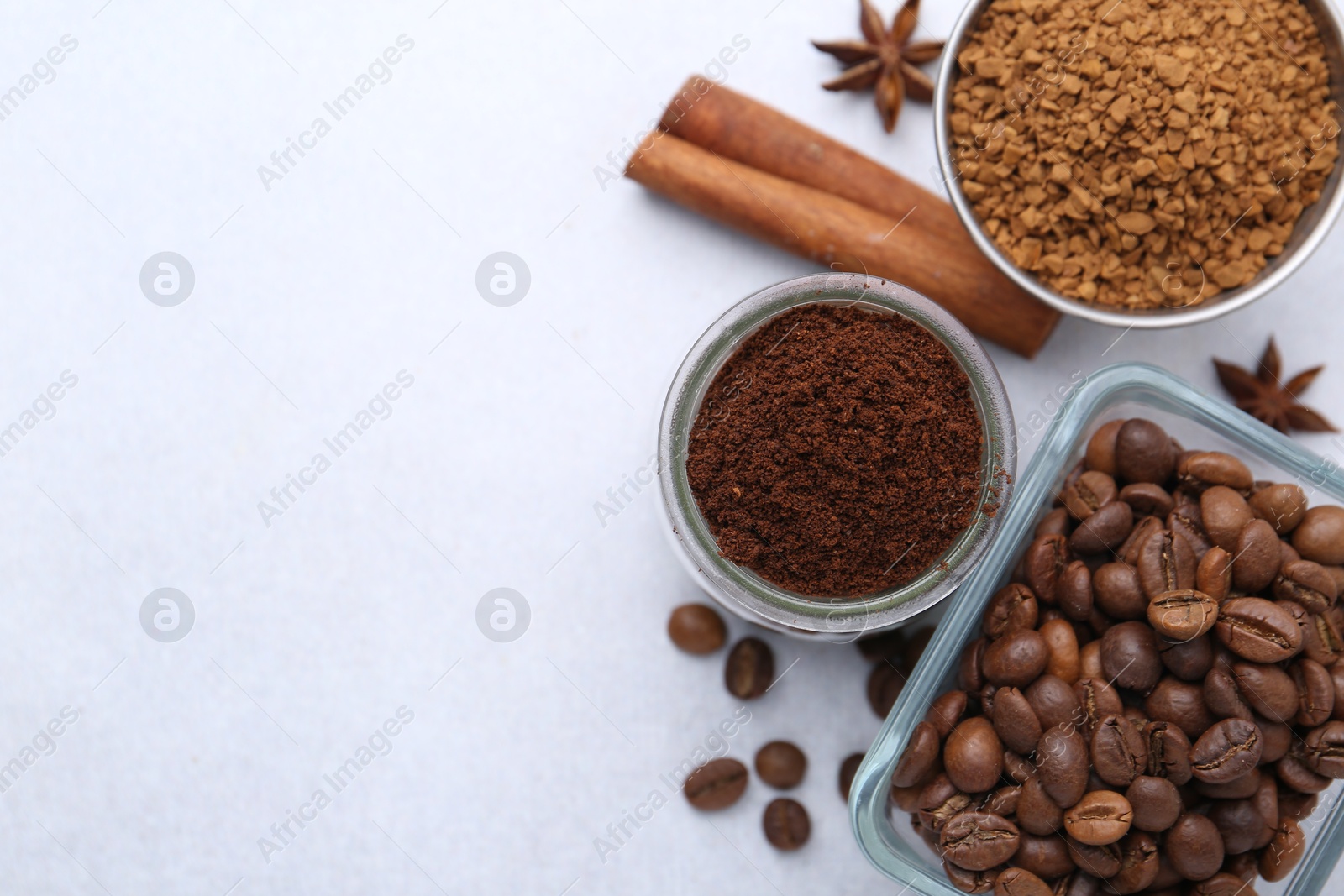 Different types of instant coffee, beans and spices on light table, flat lay. Space for text Photo of Different types of instant coffee, beans and spices on light table, flat lay. Space for text
