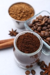 Photo of Different types of instant coffee, beans and spices on light table, closeup