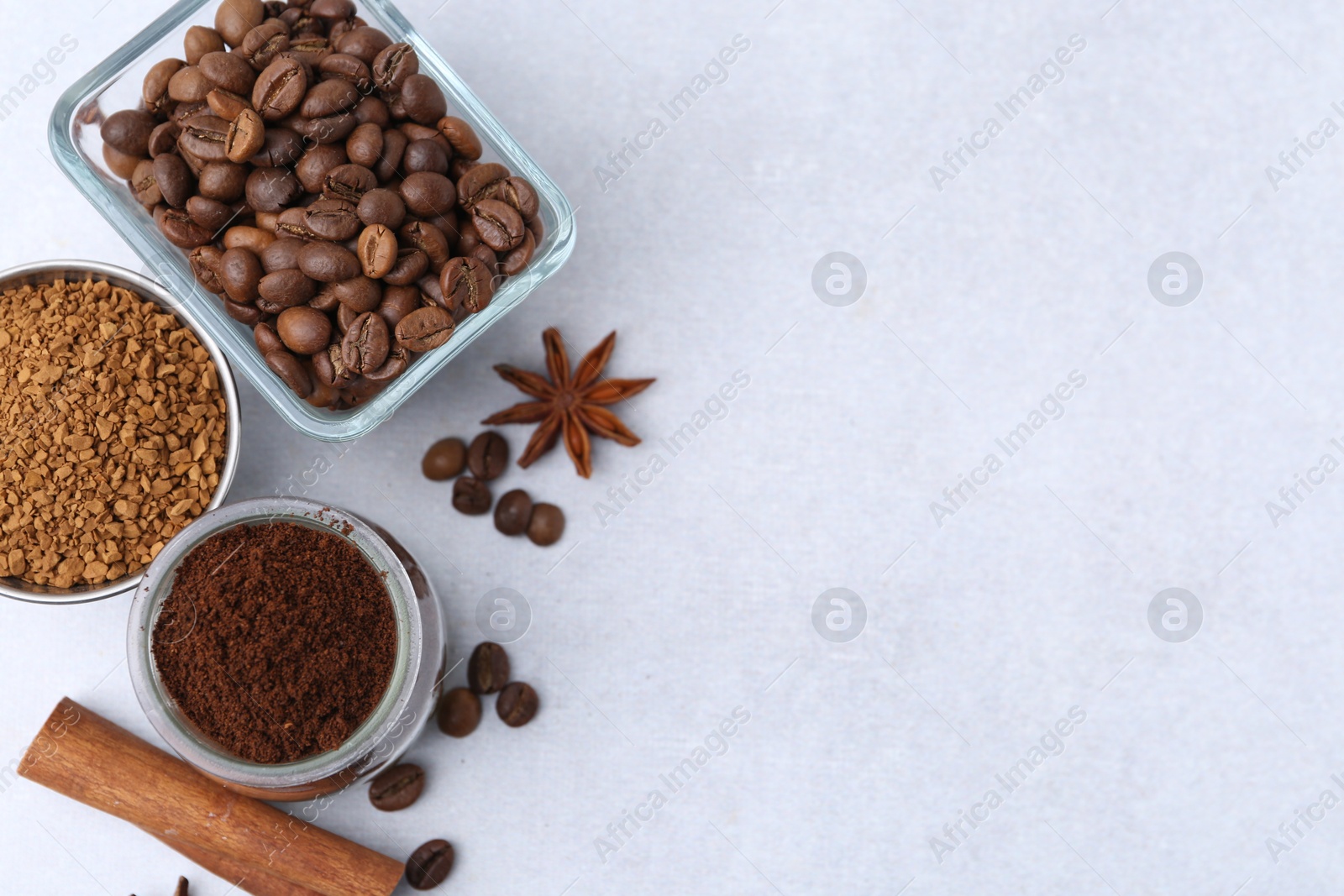 Different types of instant coffee, beans and spices on light table, flat lay. Space for text Photo of Different types of instant coffee, beans and spices on light table, flat lay. Space for text