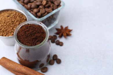 Photo of Different types of instant coffee, beans and spices on light table, closeup. Space for text