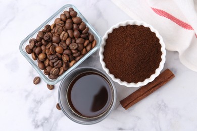 Photo of Instant coffee powder, beans and drink on white marble table, flat lay
