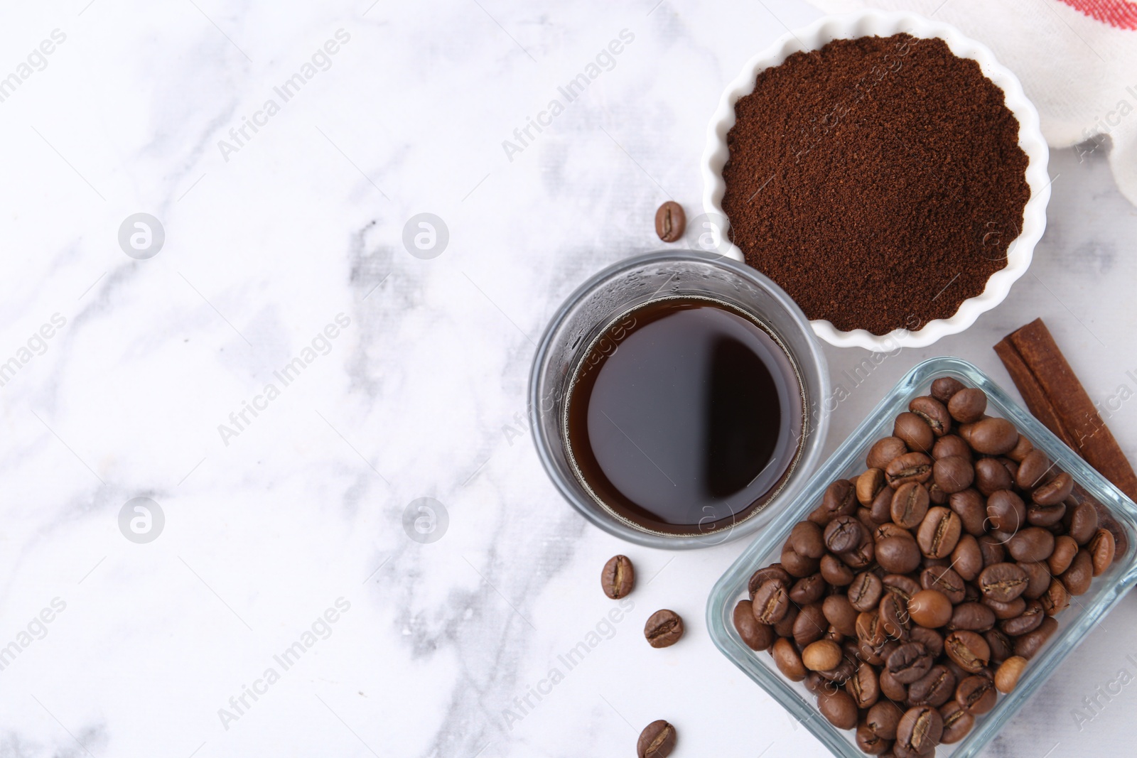 Instant coffee powder, beans and drink on white marble table, flat lay. Space for text Photo of Instant coffee powder, beans and drink on white marble table, flat lay. Space for text