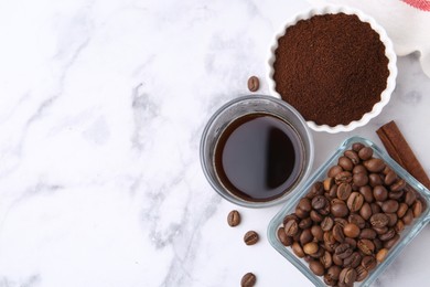 Photo of Instant coffee powder, beans and drink on white marble table, flat lay. Space for text