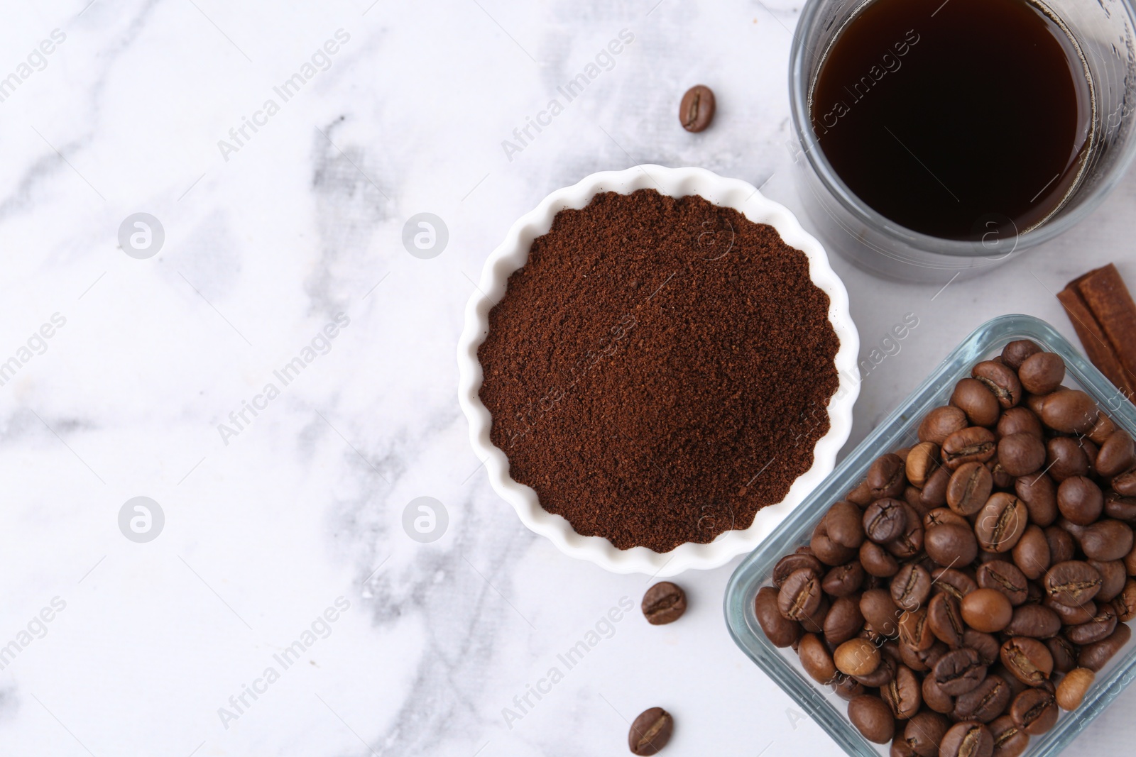 Instant coffee powder, beans and drink on white marble table, flat lay. Space for text Photo of Instant coffee powder, beans and drink on white marble table, flat lay. Space for text