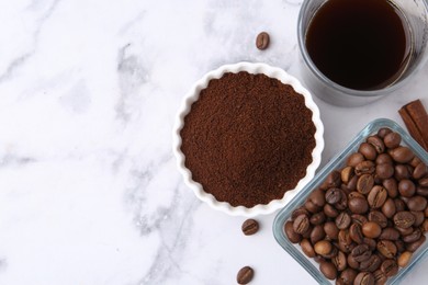Photo of Instant coffee powder, beans and drink on white marble table, flat lay. Space for text
