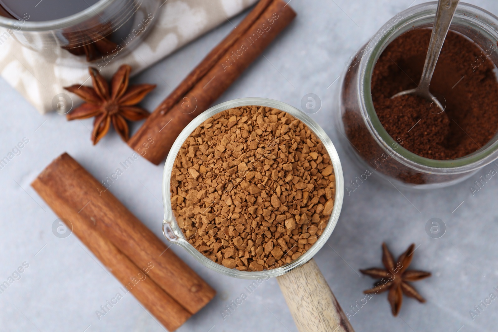 Different types of instant coffee and spices on grey table, flat lay Photo of Different types of instant coffee and spices on grey table, flat lay