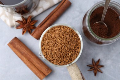 Photo of Different types of instant coffee and spices on grey table, flat lay