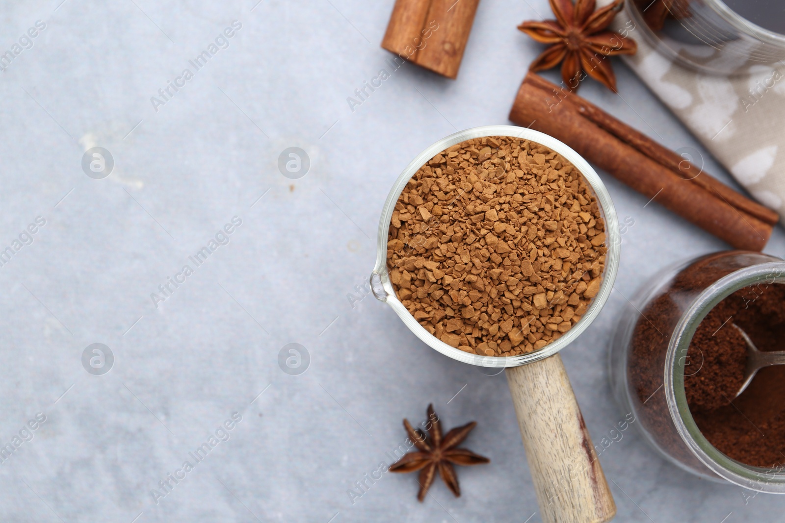 Different types of instant coffee and spices on grey textured table, flat lay. Space for text Photo of Different types of instant coffee and spices on grey textured table, flat lay. Space for text