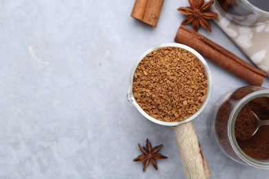 Photo of Different types of instant coffee and spices on grey textured table, flat lay. Space for text