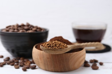 Photo of Different types of instant coffee and beans on white table, closeup