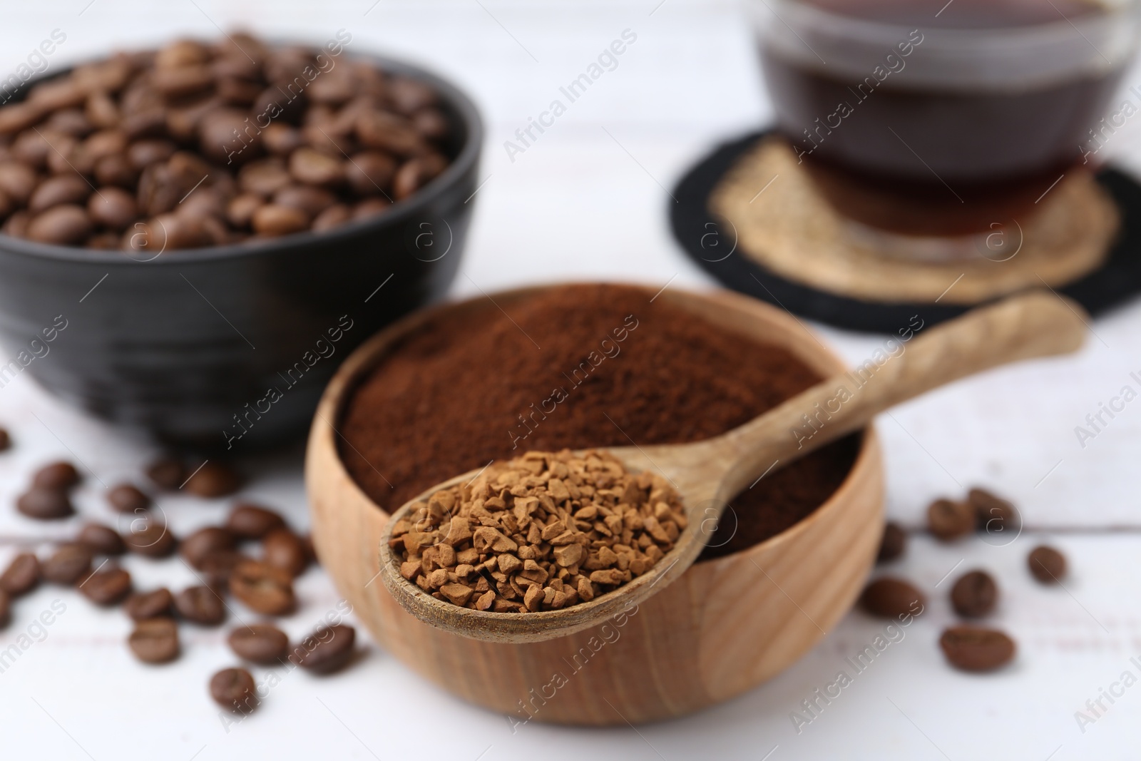 Different types of instant coffee and beans on white table, closeup Photo of Different types of instant coffee and beans on white table, closeup
