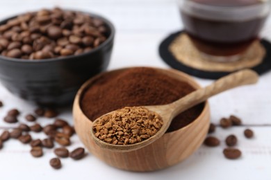 Photo of Different types of instant coffee and beans on white table, closeup
