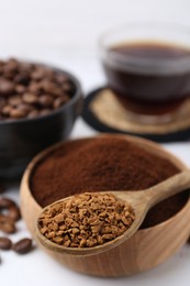 Photo of Different types of instant coffee and beans on white table, closeup
