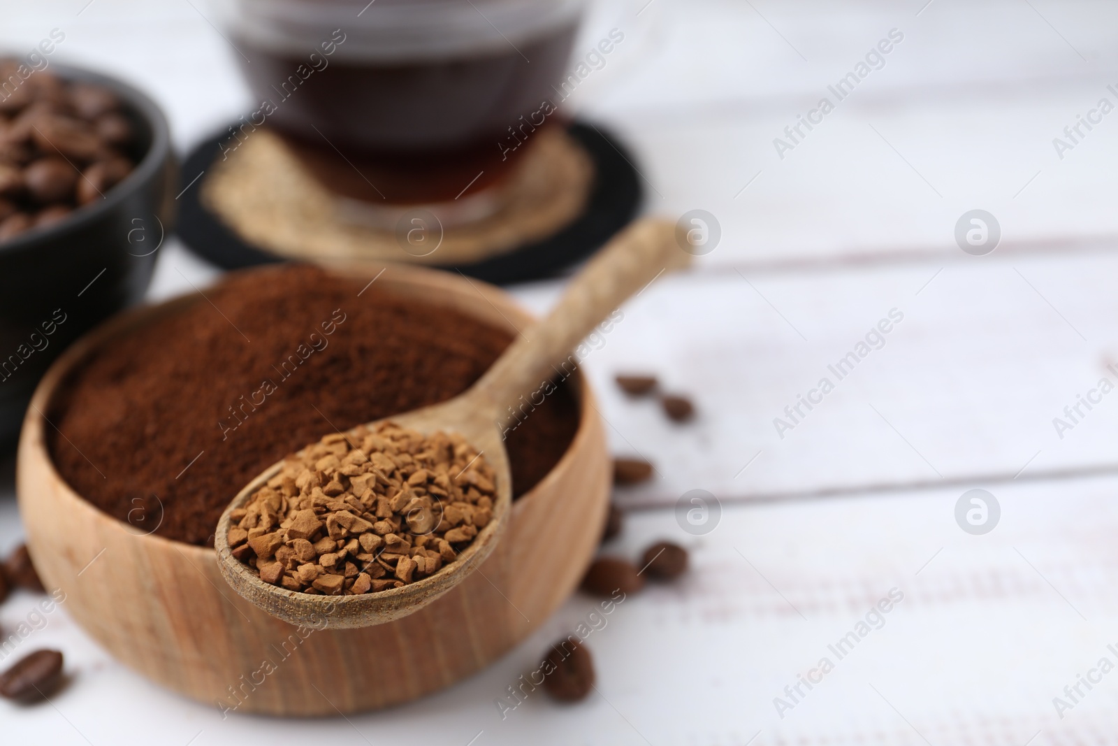Different types of instant coffee and beans on white wooden table, closeup. Space for text Photo of Different types of instant coffee and beans on white wooden table, closeup. Space for text