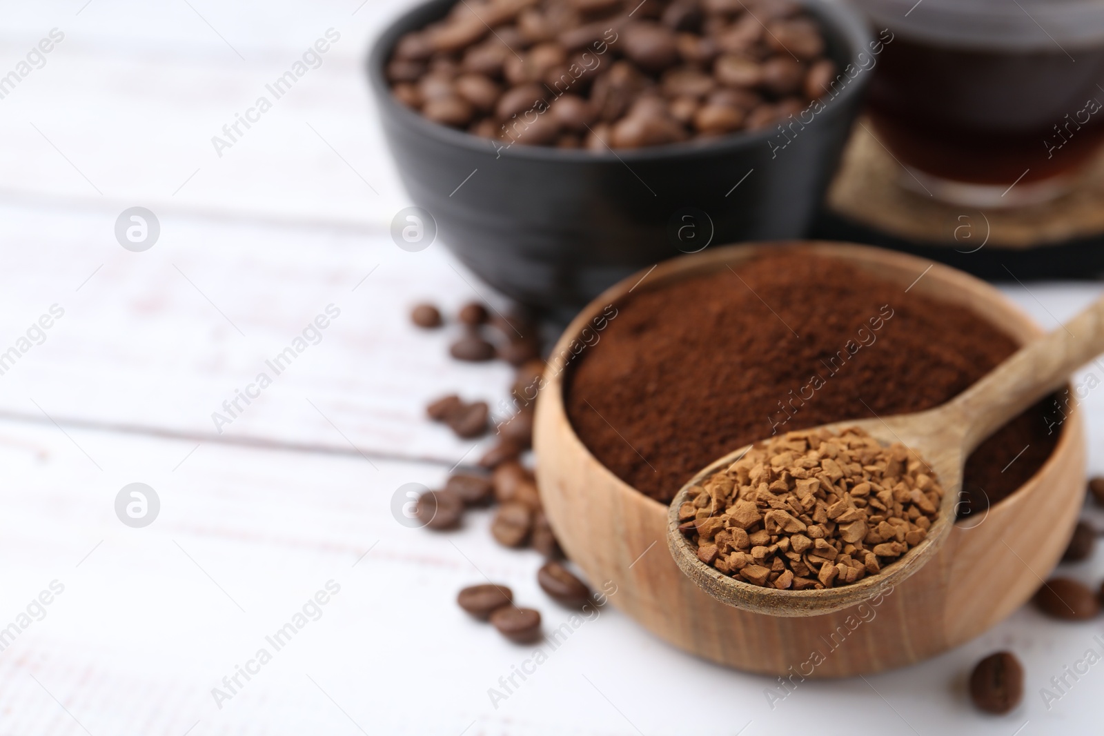 Different types of instant coffee and beans on white wooden table, closeup. Space for text Photo of Different types of instant coffee and beans on white wooden table, closeup. Space for text