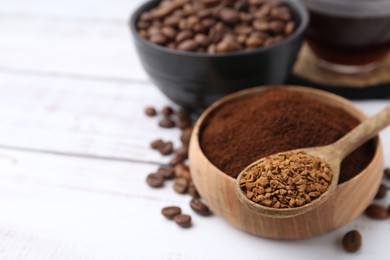 Photo of Different types of instant coffee and beans on white wooden table, closeup. Space for text