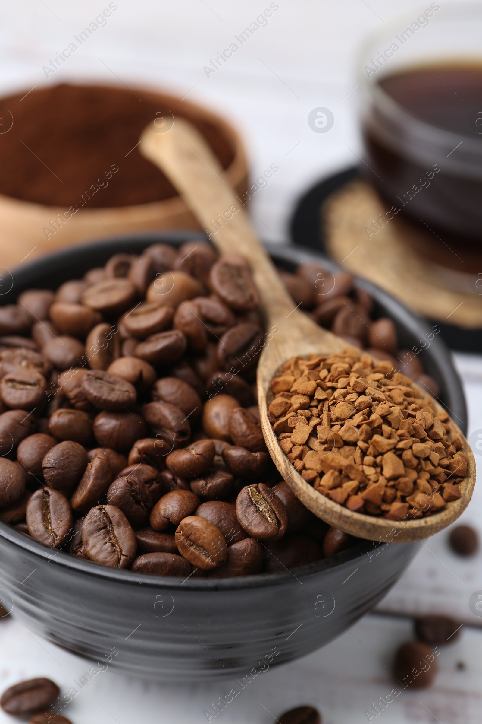 Roasted beans and granulated instant coffee on white wooden table, closeup Photo of Roasted beans and granulated instant coffee on white wooden table, closeup