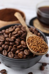 Photo of Roasted beans and granulated instant coffee on white wooden table, closeup