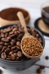 Photo of Roasted beans and granulated instant coffee on white wooden table, closeup