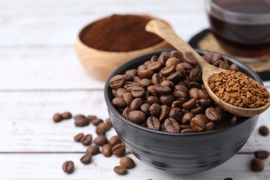 Photo of Roasted beans and granulated instant coffee on white wooden table, closeup