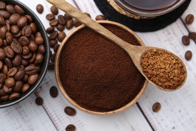 Photo of Different types of instant coffee and beans on light wooden table, flat lay