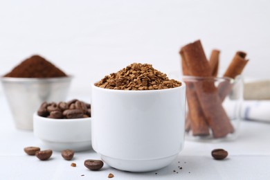 Photo of Granulated instant coffee and beans on light table, closeup
