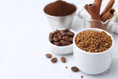 Photo of Granulated instant coffee and beans on light table, selective focus. Space for text