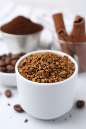 Photo of Granulated instant coffee and beans on light table, closeup