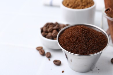 Photo of Instant coffee powder and beans on light table, selective focus. Space for text