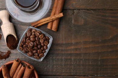 Photo of Roasted beans, instant coffee powder and cinnamon sticks on wooden table, flat lay. Space for text