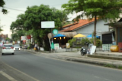 Photo of Blurred view of road with cars in city