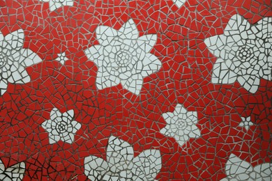 Photo of Beautiful floral design made with mosaic tiles, closeup