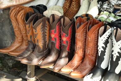 Photo of Bali, Indonesia - May 25, 2025: Different shoes on display at outdoor market, closeup
