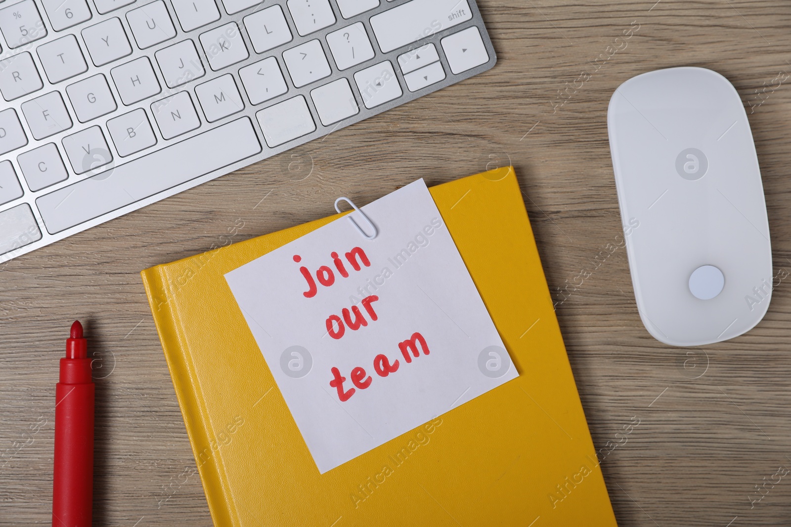 Sticky note with phrase Join Our Team, marker, notebook, computer keyboard and mouse on wooden table, flat lay Photo of Sticky note with phrase Join Our Team, marker, notebook, computer keyboard and mouse on wooden table, flat lay